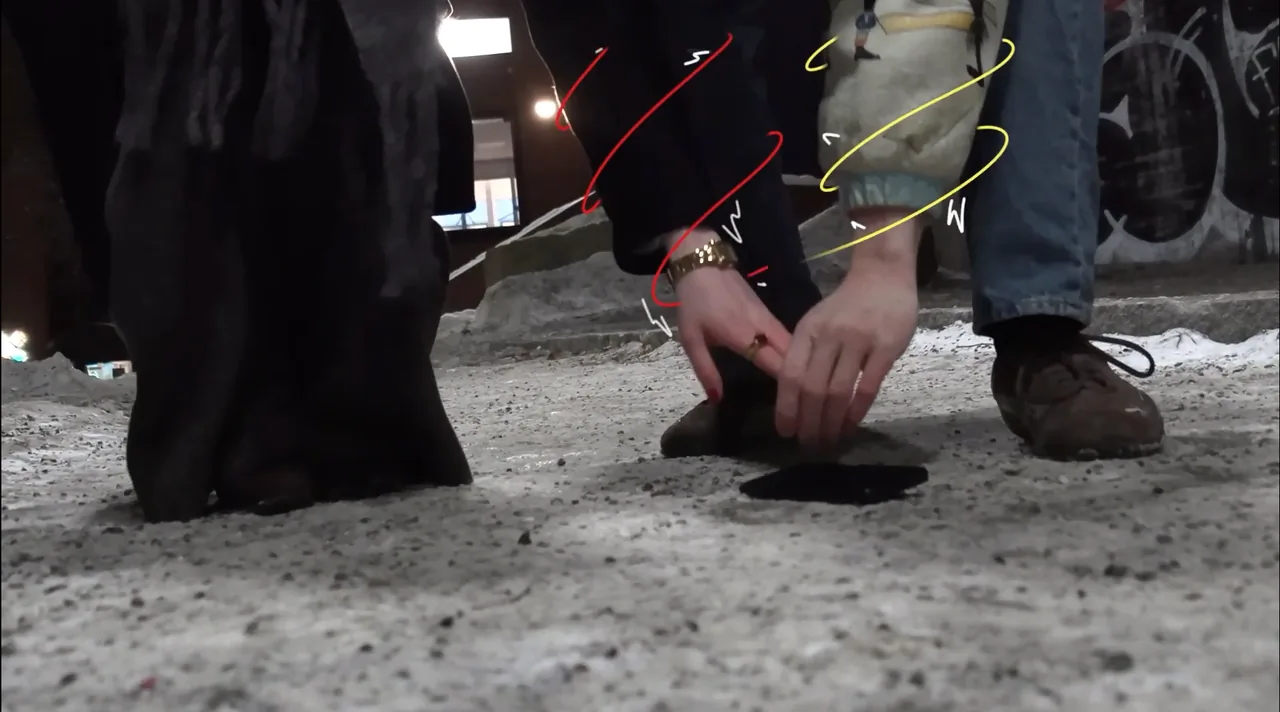 Two hands touching near a snowy concrete floor at night, from Dissociation